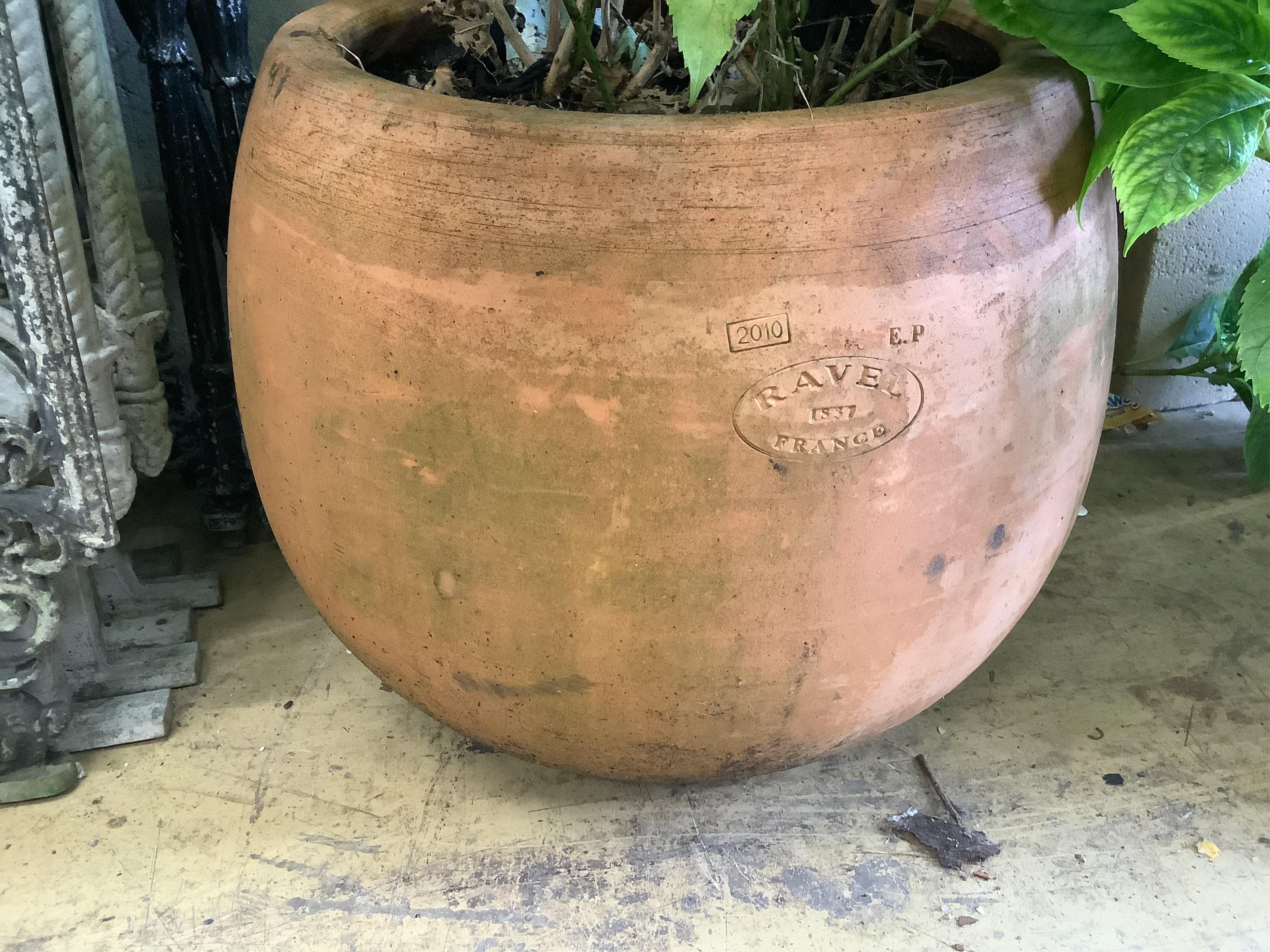 A pair of circular terracotta garden planters, stamped Ravel, France, diameter 45cm, height 40cm